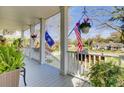 Inviting front porch with views and patriotic decor, perfect for enjoying the outdoors at 185 5Th Ave, Mount Pleasant, SC 29464