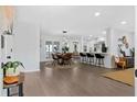 Open-concept living space featuring hardwood floors, a dining area, and modern decor at 208 James St, Summerville, SC 29483