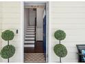 Inviting entryway with a blue front door, decorative plants, and a glimpse of the staircase at 21 America St, Charleston, SC 29403
