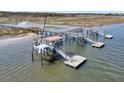 This is an aerial view of a dock with multiple slips and a covered area, providing access to the water at 2292 Beckenham Dr, Mount Pleasant, SC 29466
