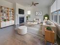 Bright living room features a fireplace, ceiling fan, hardwood floors, and a neutral color palette at 253 Palmetto Walk Dr, Summerville, SC 29486