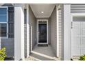 Inviting home entrance with a covered porch and modern gray finishes at 259 N Light Way, Summerville, SC 29486