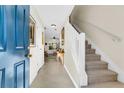 Inviting foyer featuring tile floors, staircase, and an open view into the home's living space at 303 Pine Bluff Dr, Summerville, SC 29483
