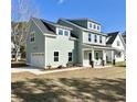 Beautiful two-story home boasting an attached garage, a covered front porch, and professional landscaping at 310 Woodland Shores Rd, Charleston, SC 29412