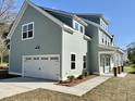 Lovely two-story home showing the garage, the covered porch, and the side entrance at 310 Woodland Shores Rd, Charleston, SC 29412