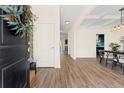 Open entryway with wood-look floors, a view of dining and kitchen, and a striking front door at 342 Saxony Loop, Summerville, SC 29486