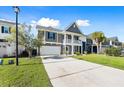 Charming two-story home with an attached garage and a well manicured lawn at 342 Saxony Loop, Summerville, SC 29486