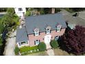 Aerial view of a brick home, highlighting its landscaped yard and recently installed gray roof at 4 Chadwick Dr, Charleston, SC 29407