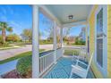 Inviting covered front porch with rocking chairs and a stylish patterned rug at 401 Forsythia Ave, Summerville, SC 29483