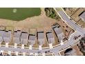 An aerial view of a residential community with houses, streets, and a pond with a fountain at 4075 Aspera Dr, Summerville, SC 29483