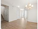 Bright entryway with hardwood floors, chandelier and view to a front door and staircase at 410 Avocet Dr, Summerville, SC 29486
