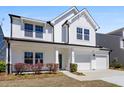 Charming two-story home featuring a two-car garage, well-maintained lawn, and inviting front porch at 410 Avocet Dr, Summerville, SC 29486