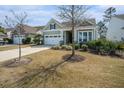 Charming home featuring a two-car garage, well-manicured lawn, and cozy front porch at 415 Four Seasons Blvd, Summerville, SC 29486