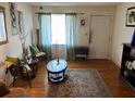 Cozy living room featuring hardwood floors, a patterned rug, and bright natural light at 4228 Oakridge Dr, North Charleston, SC 29418