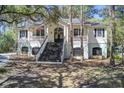 Charming two-story home with a welcoming front porch and manicured landscaping in a wooded setting at 5208 Holly Forest, Hollywood, SC 29449
