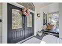 Elegant front door with decorative wreath, sidelights, and transom window, creating a warm welcome at 5208 Holly Forest, Hollywood, SC 29449