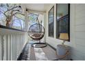 Cozy front porch with hanging chair, providing a relaxing outdoor seating area at 5208 Holly Forest, Hollywood, SC 29449