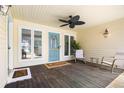 Inviting covered porch with a teal door, ceiling fan, and seating area at 5286 Waterview Dr, North Charleston, SC 29418