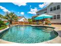 Backyard with a large in-ground pool and lush landscaping at 5556 Indigo Fields Blvd, North Charleston, SC 29418