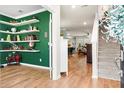 Inviting foyer with hardwood floors, staircase, decorative shelves, and a glimpse into other living spaces at 6005 Coral Berry Rd, Hanahan, SC 29410