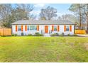 Well-maintained one-story home with white brick, bright shutters, and a manicured front lawn at 7665 Picardy Pl, North Charleston, SC 29420
