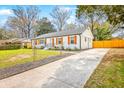 Well-maintained white brick one-story home with manicured lawn and a paved driveway at 7665 Picardy Pl, North Charleston, SC 29420