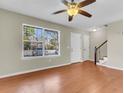 Bright living space boasts hardwood floors and a large window providing lots of natural light at 7875 Sandida Ct, North Charleston, SC 29418