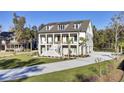 Beautiful two-story home with a double porch, showcasing a scenic view and a neatly kept lawn at 8638 Scottish Troon Ct, North Charleston, SC 29420