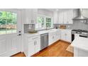 Modern kitchen with white cabinets, stainless steel appliances, and gray subway tile backsplash at 914 S Main St, Summerville, SC 29483