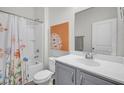 Bright bathroom featuring a shower-tub combination with curtain, neutral walls, and a stylish vanity at 9700 Flooded Field Drive Dr, Ladson, SC 29456