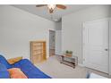 Neutral bedroom with a blue futon, offering a versatile space for relaxation or study with a doorway at 9700 Flooded Field Drive Dr, Ladson, SC 29456
