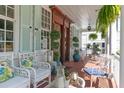 Inviting front porch with comfortable seating and views of the beautifully landscaped yard at 10 Water St, Charleston, SC 29401