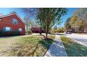 Street view of a well-maintained brick home with blue shutters and mature landscaping at 103 Haleswood Cir, Goose Creek, SC 29445