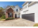 A two-story brick and white siding home with a two-car garage and well-manicured landscaping at 104 Abrum Ct, Goose Creek, SC 29445