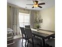 Cozy dining room with a modern ceiling fan and ample natural light from the large window at 104 Salem Rd, Ladson, SC 29456