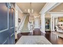 Spacious foyer with hardwood floors, elegant staircase, and decorative display cabinet at 106 Murray Blvd, Charleston, SC 29401