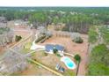 Expansive aerial view showcasing the home, large lot, swimming pool, and mature trees at 1158 Wildgame Rd, Summerville, SC 29486