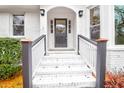 Inviting front entrance with white stairs, a dark door, and decorative lighting fixtures at 1158 Wildgame Rd, Summerville, SC 29486