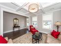 Bright living room featuring a coffered ceiling, hardwood floors, and large windows at 1166 Elliotts Cut Dr, Charleston, SC 29412