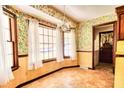 Bright dining area with floral wallpaper, large windows, and tile flooring at 1198 Oakcrest Dr, Charleston, SC 29412