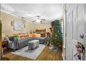 Inviting living room with a gray sofa, area rug, ceiling fan, and festive holiday decorations at 120 Luden Dr # C, Summerville, SC 29483