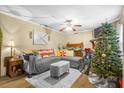 Inviting living room with a gray sofa, area rug, ceiling fan, and festive holiday decorations at 120 Luden Dr # C, Summerville, SC 29483