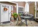 Cozy patio area with table, chairs, umbrella, and potted plants creating an inviting outdoor space at 120 Luden Dr # C, Summerville, SC 29483