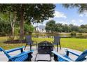 Inviting backyard patio with a fire pit, chairs, and a serene pond view, perfect for relaxing at 1232 Palmetto Peninsula Dr, Mount Pleasant, SC 29464