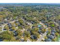 Expansive aerial view of a neighborhood with lush greenery, waterways, and a community pool at 1324 Southlake Dr, Mount Pleasant, SC 29464