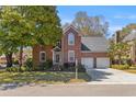 Beautiful brick home with a two-car garage, lovely front yard, and manicured landscaping at 1324 Southlake Dr, Mount Pleasant, SC 29464