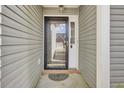 A well-lit front porch with an ornate door mat and a screen door with glass panes at 136 Rosario Dr, Summerville, SC 29483