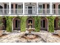 Picturesque courtyard featuring a central fountain, arches covered in greenery, and a gravel pathway at 14 Greenhill St, Charleston, SC 29401