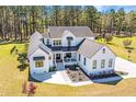 Stylish two-story farmhouse featuring black trim and a spacious front yard and green lawn at 161 Ryefield Ln, Ridgeville, SC 29472