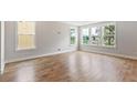 Bright living room with large windows and beautiful hardwood floors at 1683 Cultivation Ln # 460, Mount Pleasant, SC 29466